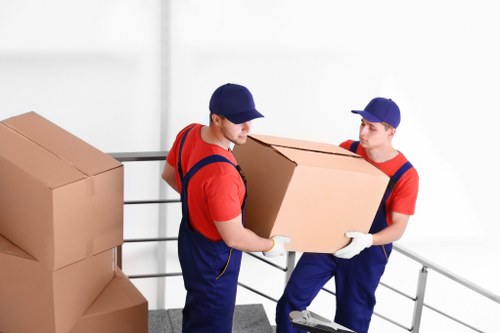 Removal team preparing items safely with protective handling equipment