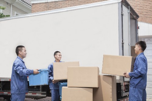 Professional movers loading household furniture carefully