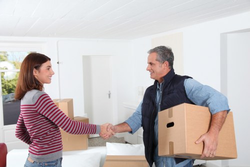Loading household boxes and furniture into a removal van for a Westealing move