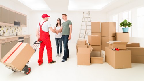 Removal team unloading items at a new Westealing home